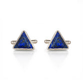 Pair of triangle-shaped cufflinks with blue stone centers on a white background