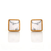 Square stud earrings with marble pattern and gold frame on a white background