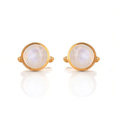 Pair of gold earrings with round moonstone stones on a white background