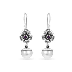 Silver earrings with floral designs and purple gemstones on a white background