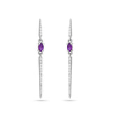 Pair of silver earrings with purple gemstones on a white background