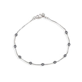 Silver bracelet with small beads on a white background