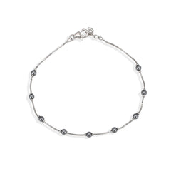Silver bracelet with small beads on a white background