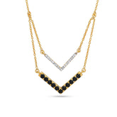 Gold necklace with black and white gemstones on a white background