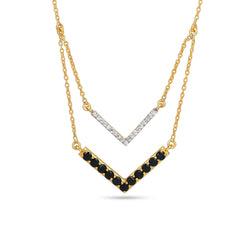 Gold necklace with black and white gemstones on a white background