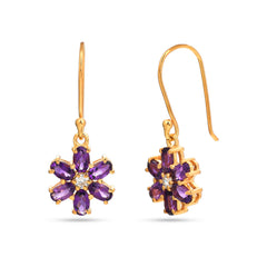 Gold earrings with purple gemstones on a white background