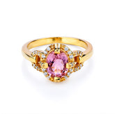 Gold ring with a pink gemstone on a white background