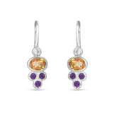 Silver earrings with orange and purple gemstones on a white background