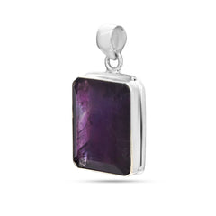 Silver pendant with a purple gemstone on a white background