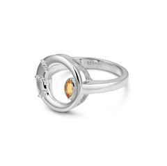 Silver ring with a central yellow gemstone and smaller diamonds on a white background