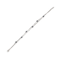 Silver bracelet with black beads on a white background