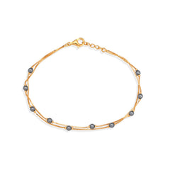 Gold bracelet with gray beads on a white background