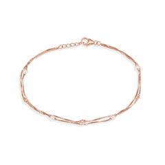 Rose gold bracelet with pearls on a white background