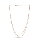 Long necklace with rose gold chain and pearls on a white background