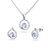 Silver jewelry set with spiral design on a white background