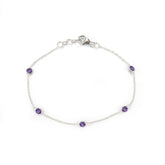 Silver bracelet with purple gemstones on a white background