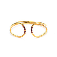 Gold bracelet with red gemstones on a white background