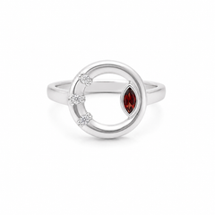 A silver ring featuring a circular openwork design with a marquise-cut red gemstone and three small clear accent stones, shown on a plain white background.