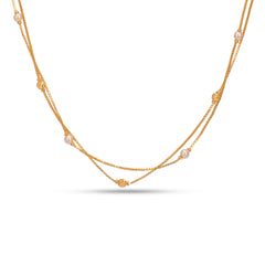 Gold necklace with pearls on a white background