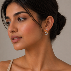 Close-up of a woman wearing a unique earring with a neutral background