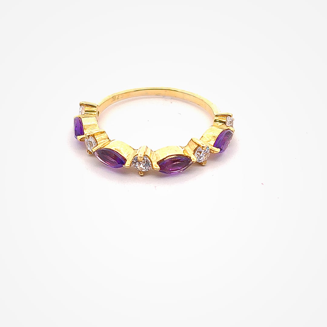 Gold ring with purple gemstones on a white background