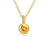 Gold necklace with a round pendant on a white background