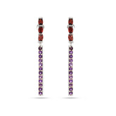 Pair of earrings with red and purple gemstones on a white background