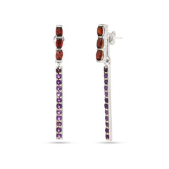 Pair of earrings with red and purple gemstones on a white background