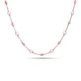 Pearl necklace with pink beads on a white background