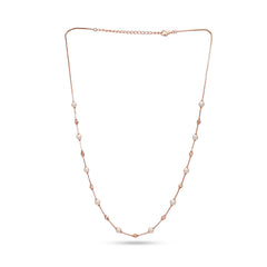 Rose gold necklace with pearls on a white background