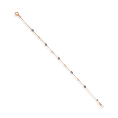 Gold bracelet with black beads on a white background