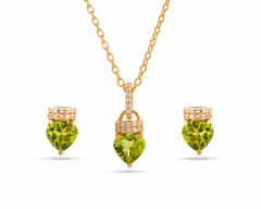 Gold necklace with heart-shaped green gemstones on a white background
