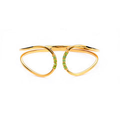 Gold bracelet with green gemstones on a white background