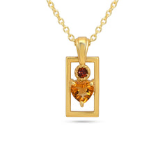 Gold pendant with heart-shaped gemstone on a white background