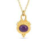 Gold necklace with a purple gemstone pendant on a white background
