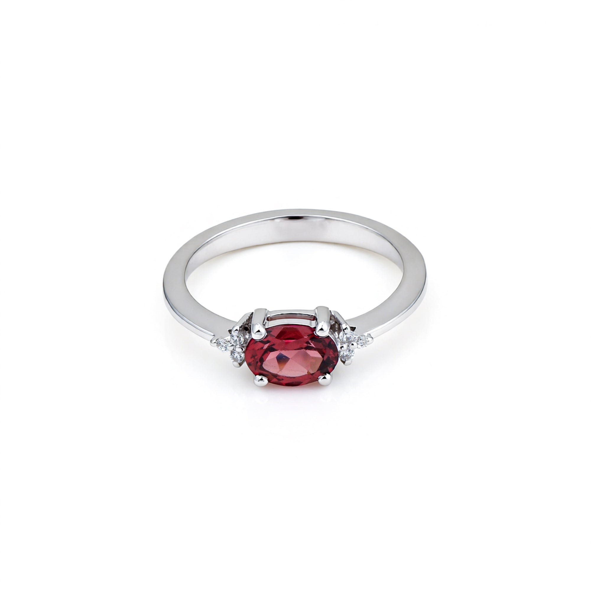 Silver ring with a red gemstone on a white background