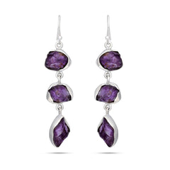 Pair of silver earrings with purple gemstones on a white background