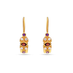 Gold earrings with gemstones on a white background