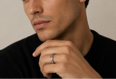 Man wearing a black sweater with a neutral background