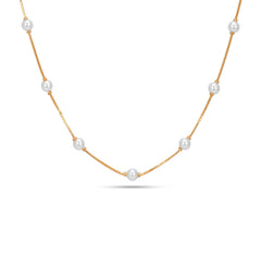 Gold necklace with pearls on a white background