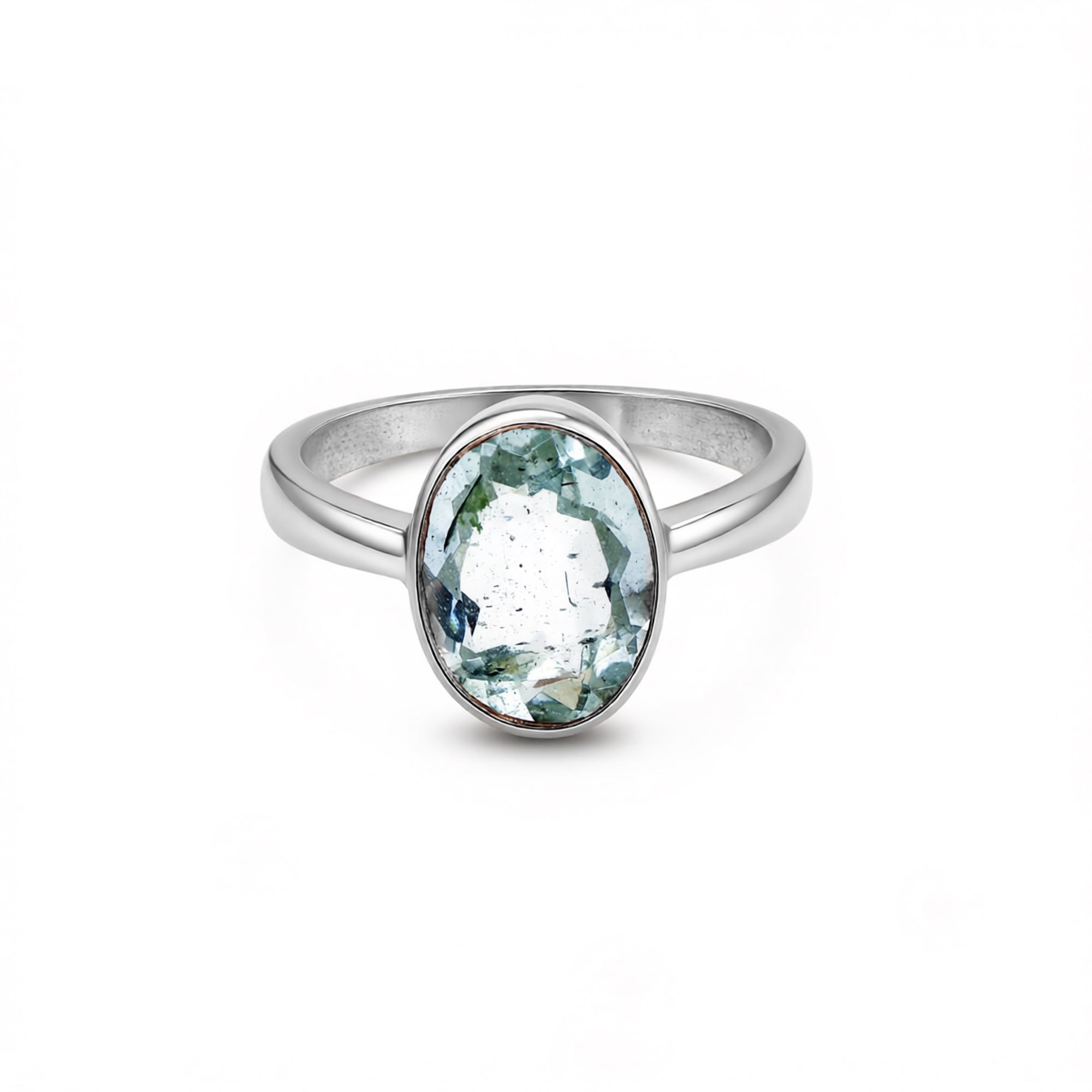 Silver ring with a green gemstone on a white background