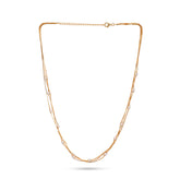 Gold necklace with small pearls on a white background