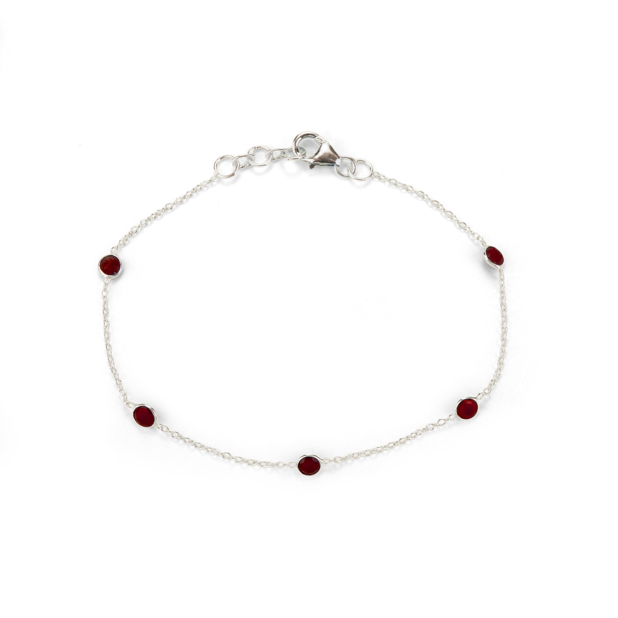 Silver bracelet with red gemstones on a white background