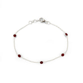 Silver bracelet with red gemstones on a white background
