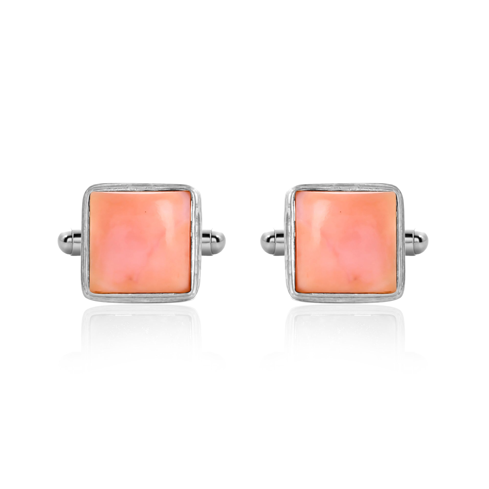 Pair of square pink cufflinks with silver borders on a white background