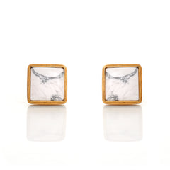 Square stud earrings with marble pattern and gold frame on a white background