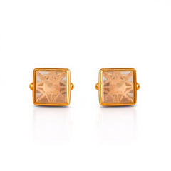 Gold square-shaped earrings with clear gemstones on a white background