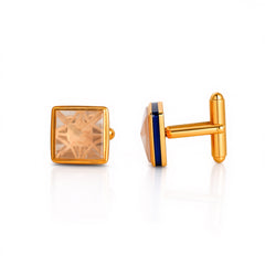 Gold cufflinks with square gemstones on a white background