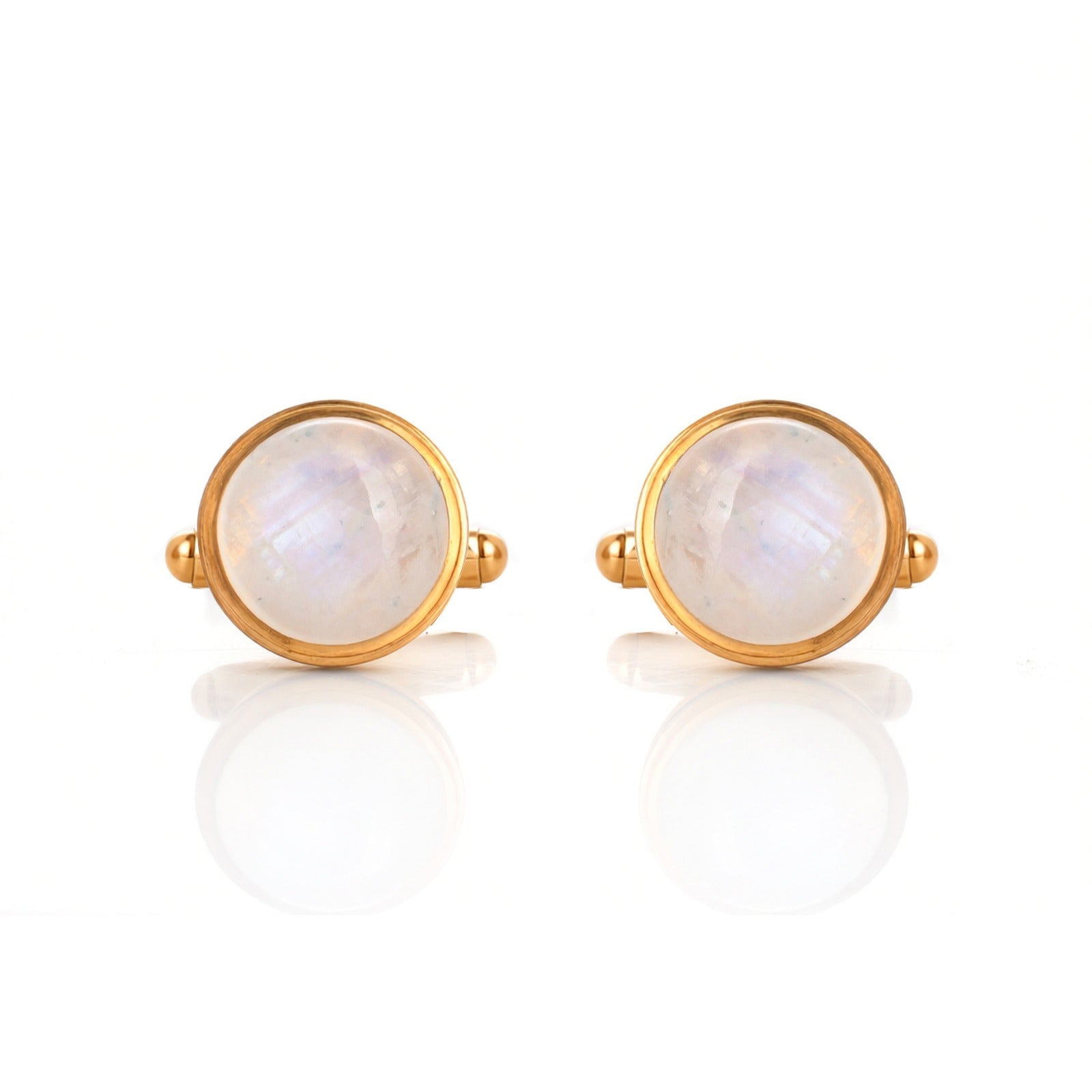 Pair of gold earrings with round moonstone stones on a white background