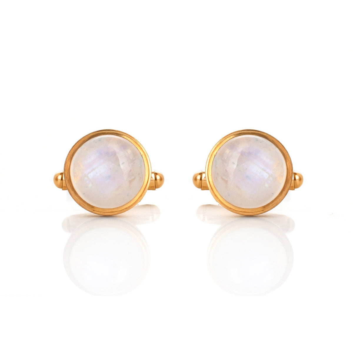 Pair of gold earrings with round moonstone stones on a white background